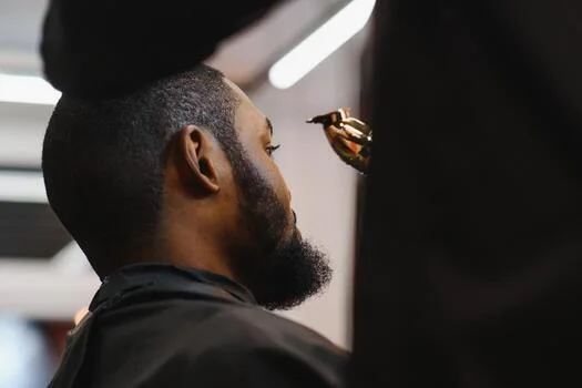 Barber trimming a client's beard