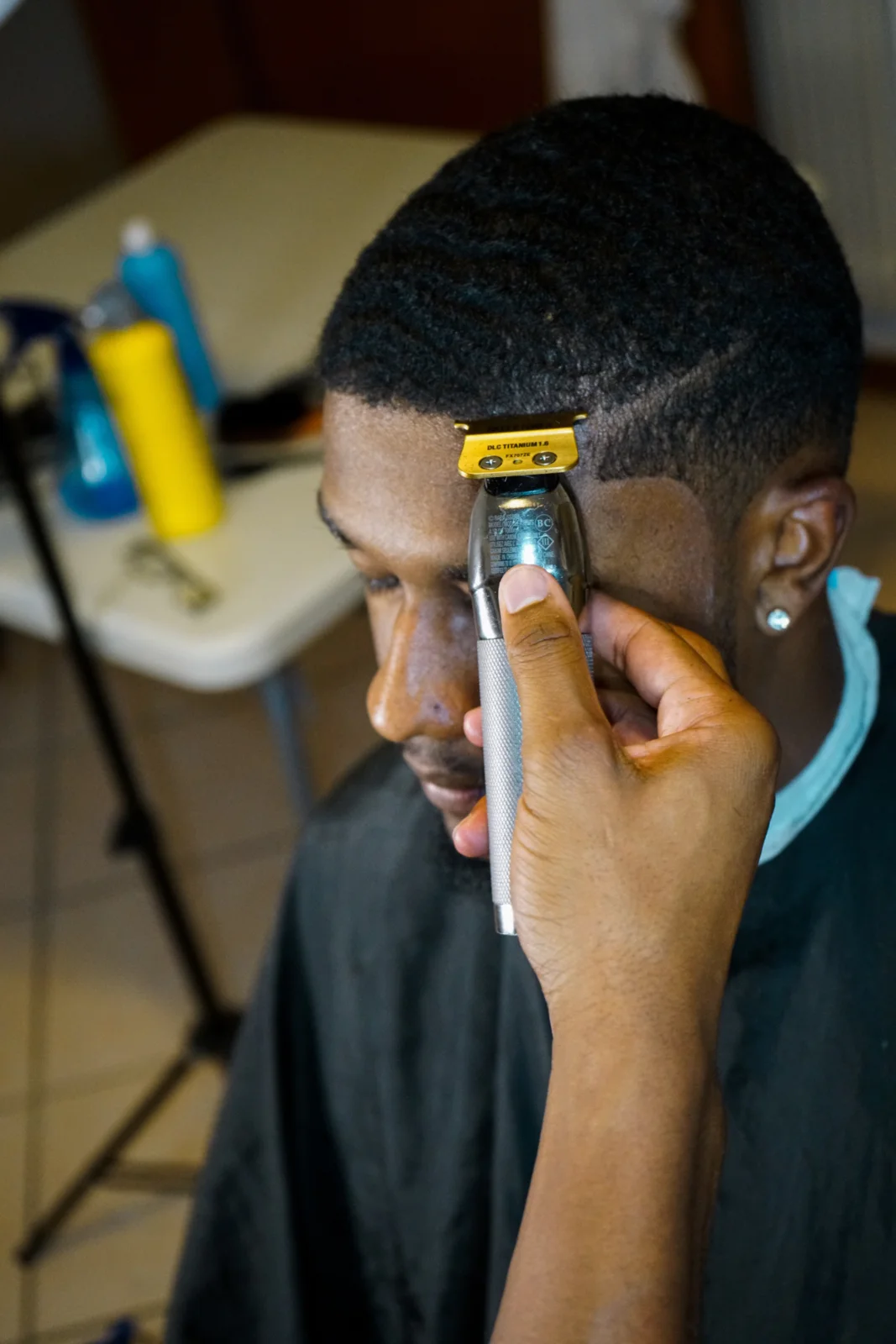 Barber creating a clean edge up with trimmers