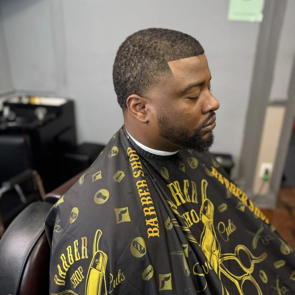 Finished men's haircut with a clean hairline and beard