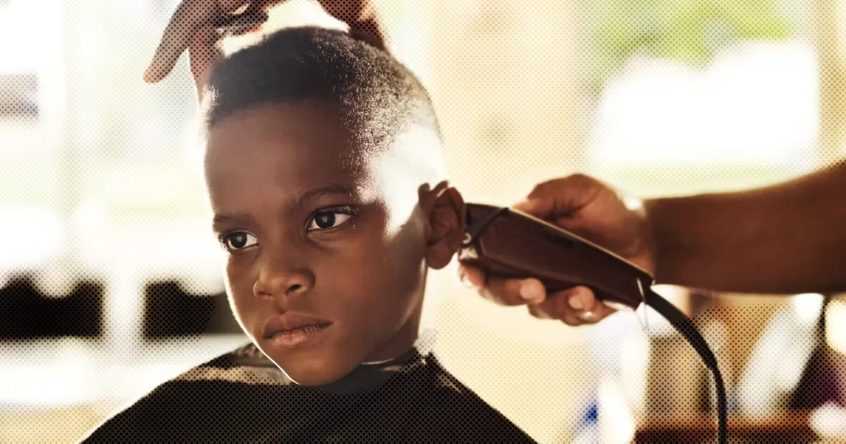 Child receiving a haircut with clippers